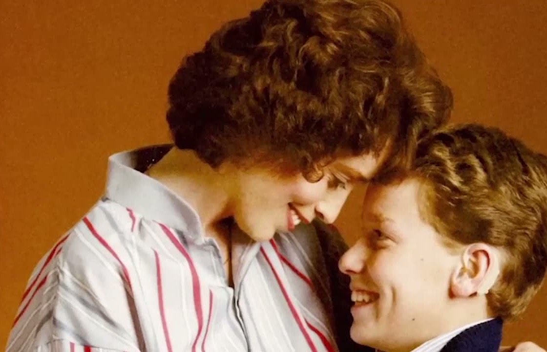 Claudia Anderson and her son, smiling forehead to forehead, in a still from the film